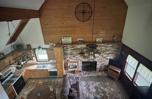 Longleaf Cabin | Cozy Cabin setting behind a 1 1/2 acre pond that is lined with Cypress Trees.