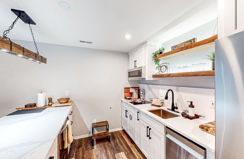The Wedge House | Modern lower-level getaway with a fireplace, inviting patio & washer/dryer