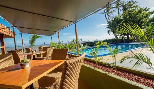 Your Ultimate Oceanfront Retreat | Relaxing Room with Lush Garden View